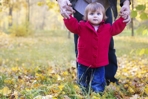 child walking with parent on the grass