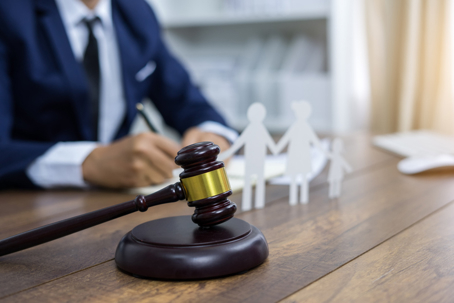 Attorney at desk with family figure